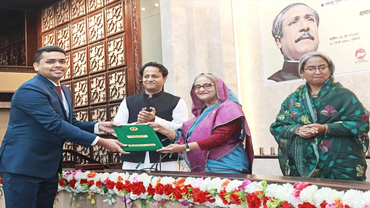 প্রধানমন্ত্রী শেখ হাসিনার হাত থেকে প্রাইজ মানি, সার্টিফিকেট ও ক্রেস্ট গ্রহণ করছেন মো. ইব্রাহীম আজাদ। ছবি : কালবেলা