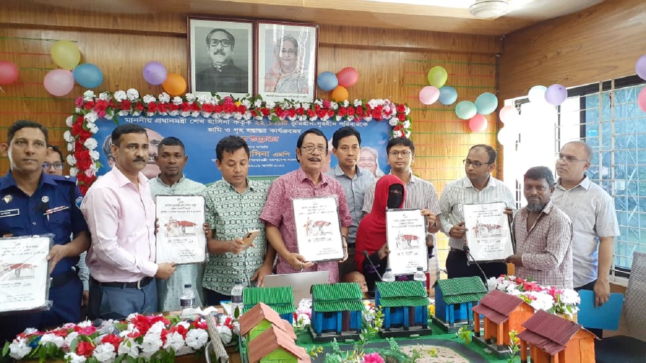 রাঙ্গুনিয়ায় সরকারি আশ্রয়ণ প্রকল্পে ঘর পাওয়া বাসিন্দারা দলিল হাতে অতিথিবৃন্দের সঙ্গে। ছবি: কালবেলা