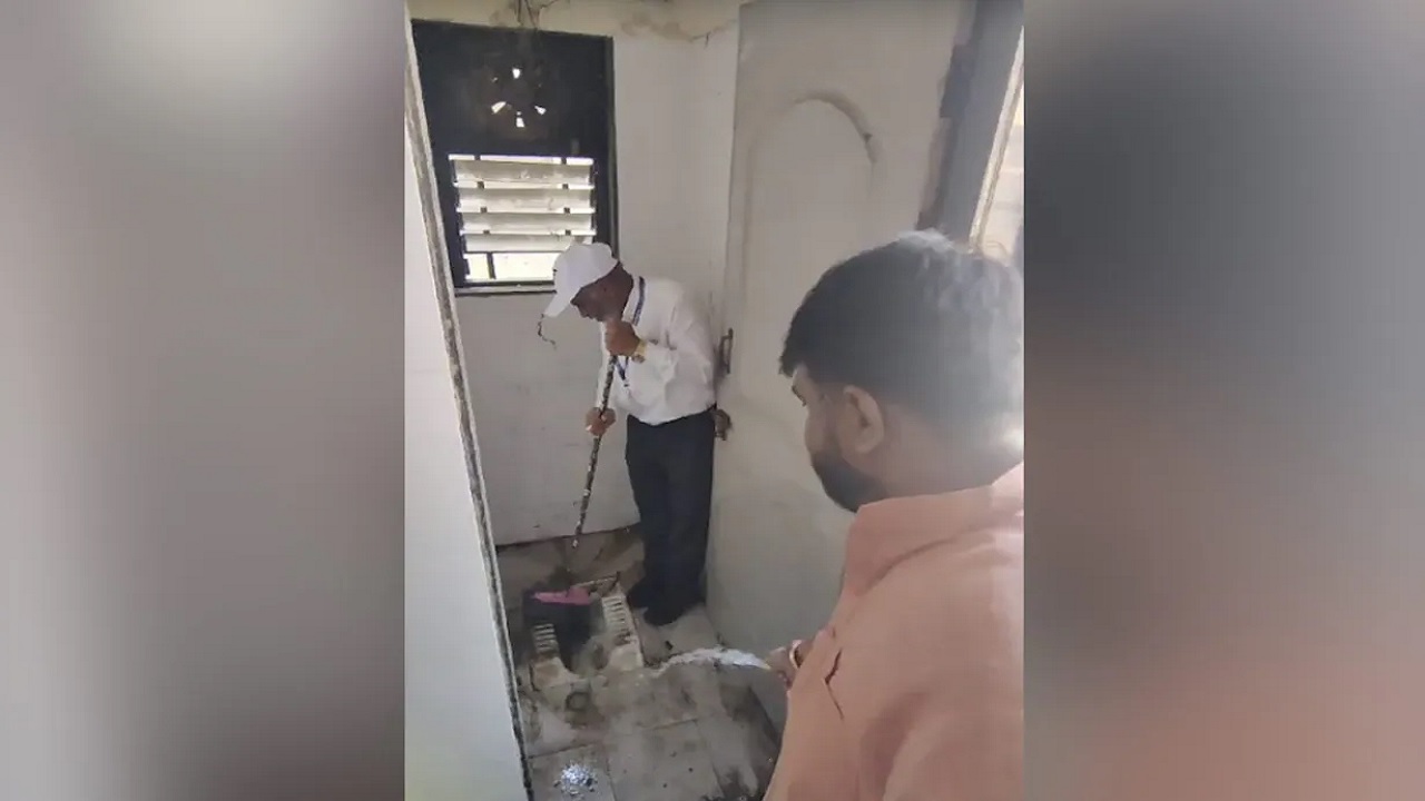 এমপি পাইপ দিয়ে পানি দিচ্ছেন আর হাসপাতালপ্রধান টয়লেট পরিষ্কার করছেন। ছবি :  এনডিটিভি