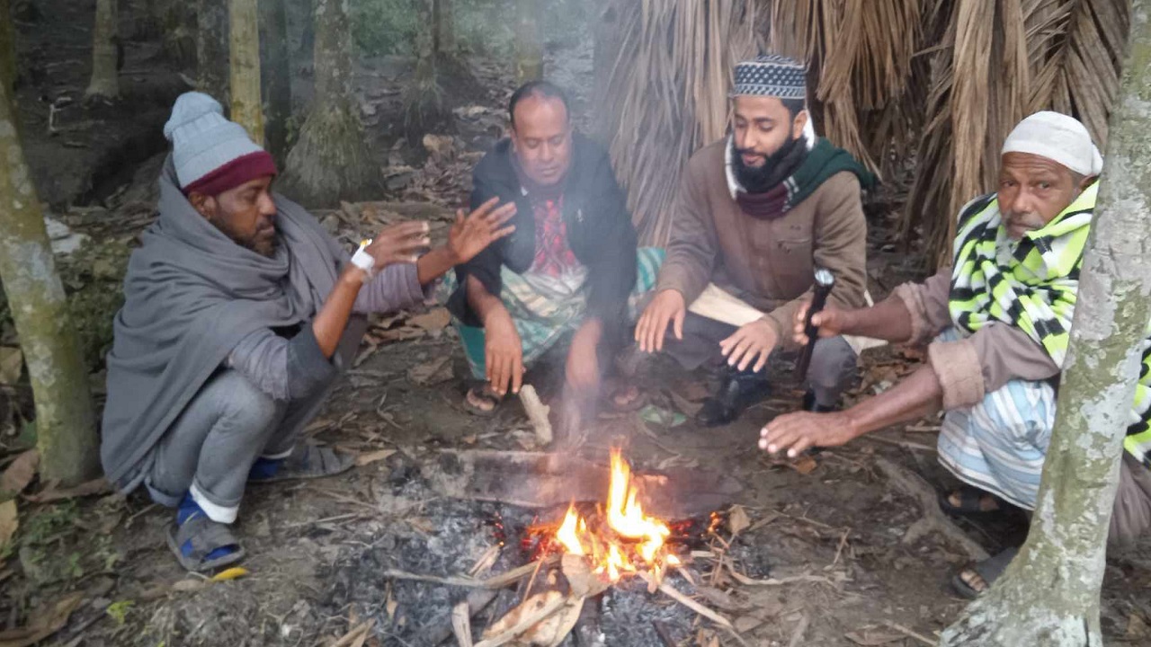 আগুন জ্বালিয়ে শীত নিবারণের চেষ্টা করছেন মেঘনা ও ডাকাতিয়া নদীবেষ্টিত চরাঞ্চলের মানুষজন। ছবি : কালবেলা