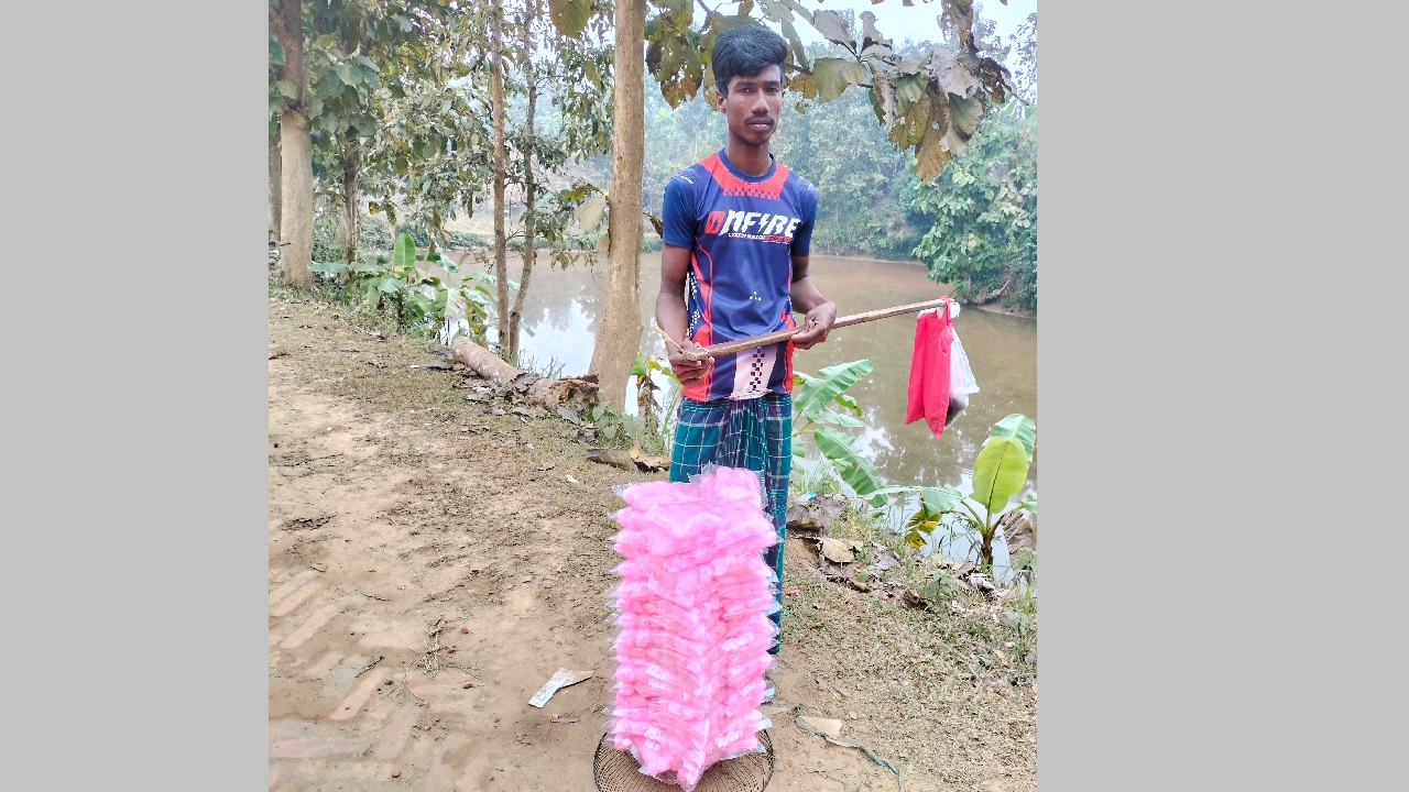 হাওয়াই মিঠাই নিয়ে ক্রেতার অপেক্ষায় আসাদুল ইসলাম। ছবি : কালবেলা