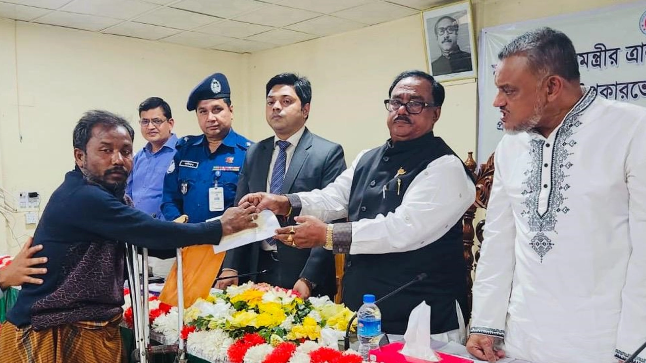 চেক বিতরণ করছেন খাদ্যমন্ত্রী সাধন চন্দ্র মজুমদার। ছবি : কালবেলা