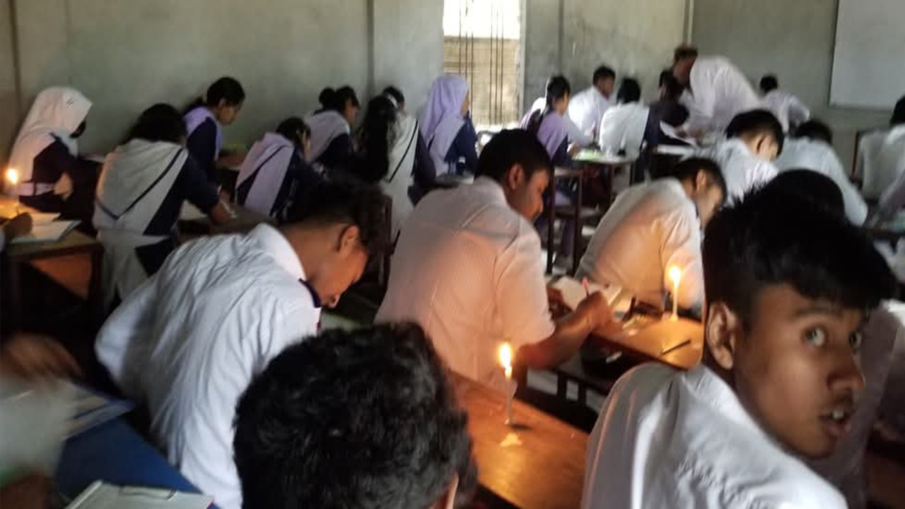 মোমবাতি জ্বালিয়ে পরীক্ষা দিচ্ছেন পরীক্ষার্থীরা। ছবি : কালবেলা